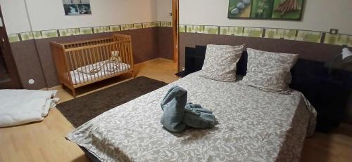 a room with a bed with a stuffed animal on it at House surrounded by creek in La Bresse