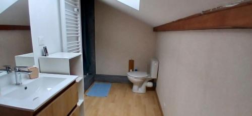 a bathroom with a sink and a toilet at House surrounded by creek in La Bresse