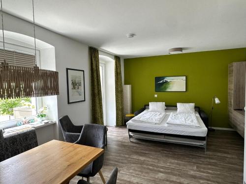 a bedroom with a bed and a table and chairs at Appartement Marlene in Maishofen