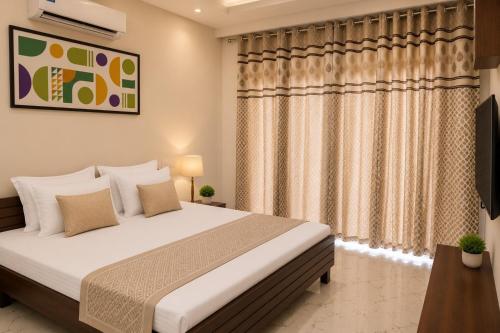 a bedroom with a bed and a television at Hotel IT Park Home Stay Near DLF City Centre Mall in Manī Mājra