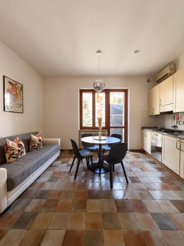 a living room with a couch and a table at Giuditta Apartment in Ciriè