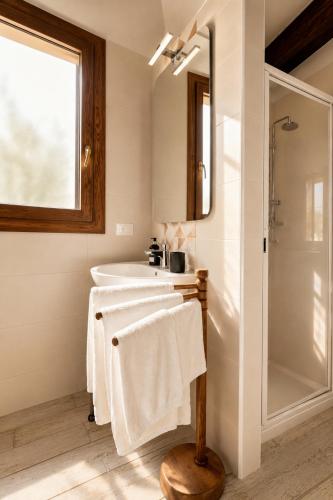 a bathroom with a tub and a sink and a mirror at Casa Due Marie Boutique stay near Modena & Maranello in Marano sul Panaro