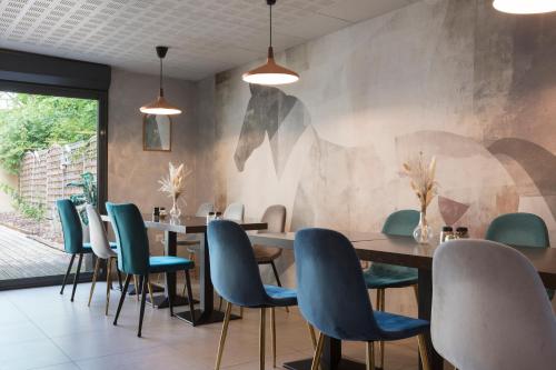 a dining room with a table and chairs at Sure Hotel by Best Western Reims Nord in Reims
