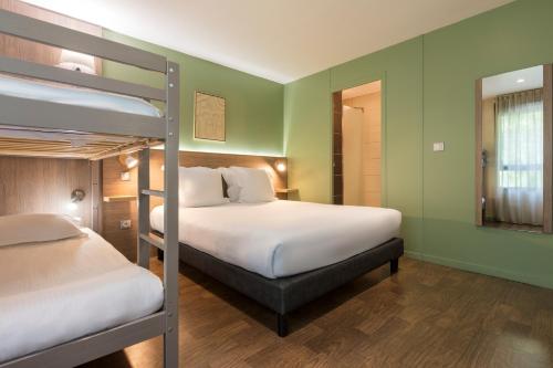 two bunk beds in a room with green walls at Sure Hotel by Best Western Reims Nord in Reims