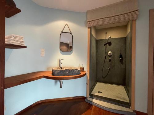 a bathroom with a sink and a shower at Authentique gite de village in Hotton