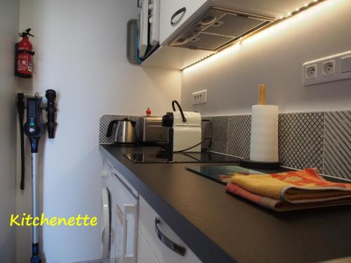 a kitchen with a sink and a counter top at Une Heure Bleue in Manosque
