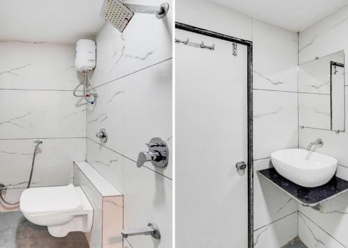 a white bathroom with a toilet and a sink at Hotel Lakeview Vadodara in Vadodara
