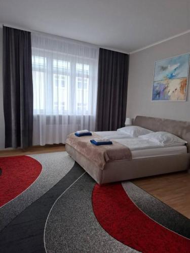 a bedroom with a bed and a large window at Baltic Plaza Gdynia - MAXIMAL in Gdynia