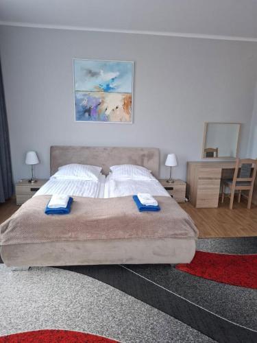 a bedroom with a bed with two towels on it at Baltic Plaza Gdynia - MAXIMAL in Gdynia