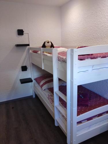 a bunk bed with a teddy bear sitting on top at Lucys Bungalow in Butjadingen