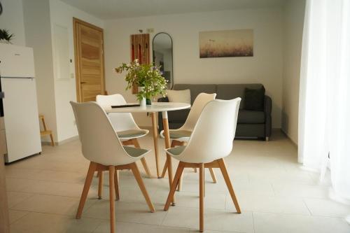 a dining room with a table and white chairs at FeWo Reutlingen Ganghoferstr in Reutlingen