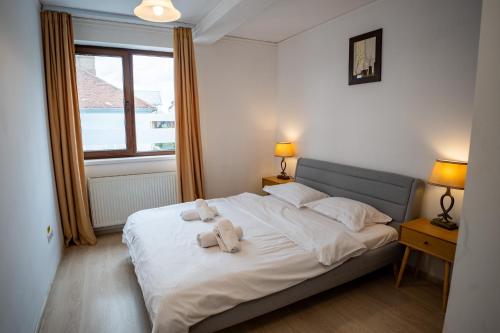 a bedroom with a bed with two stuffed animals on it at Barrique 24-4 - Breakfast delivered & Minibar - Free Parking -Officially classified guesthouse in Braşov