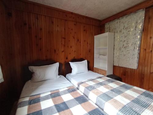 two beds sitting next to each other in a room at Andrea's hays in Kobuleti
