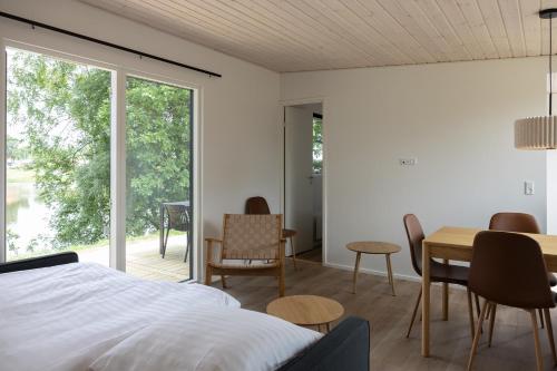 a bedroom with a bed and a table and chairs at Holstebro Søpark in Holstebro