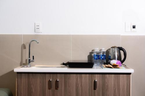a kitchen with a sink and a counter top with aounter at Danna House Da Nang BNB in Danang