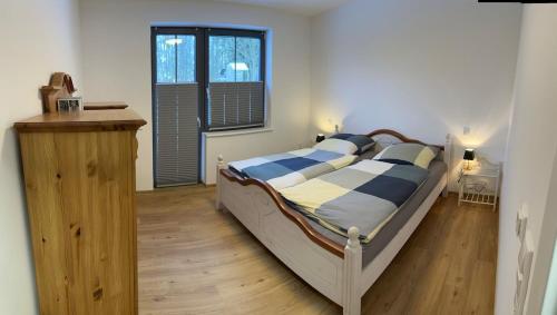 a bedroom with a large bed and a wooden floor at Ruhig wohnen in Hüttblek in Hüttblek