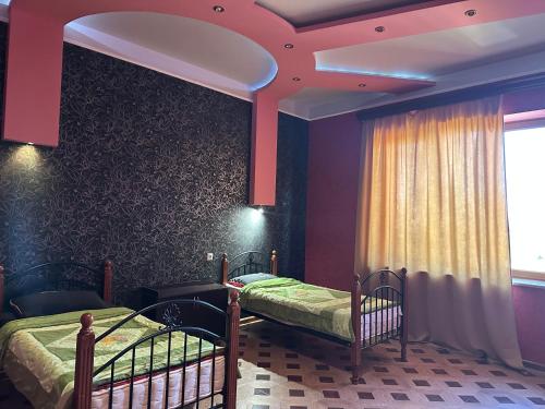 a bedroom with two twin beds and a window at Dom in Aygavan