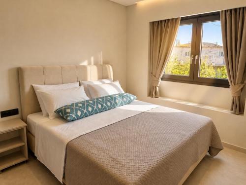 a bedroom with a large bed and a window at Amara 2 bedrooms apartment - Alykanas in Alikanas