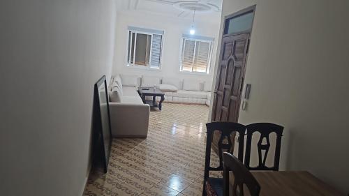 a living room with a couch and a table and chairs at La Casa de Madrid in Larache