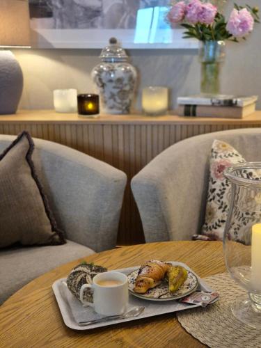 a table with a plate of food and a cup of coffee at Hotell Rådhuset in Lidköping