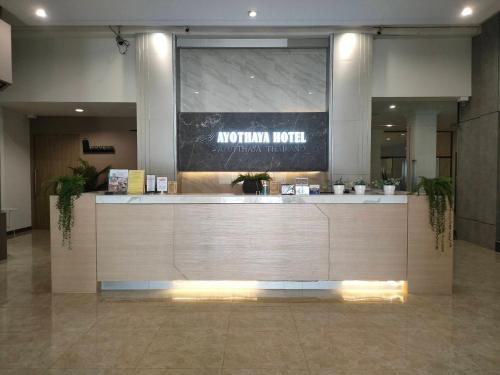 a lobby with a reception desk in a building at Sunday Ayothaya Hotel in Phra Nakhon Si Ayutthaya