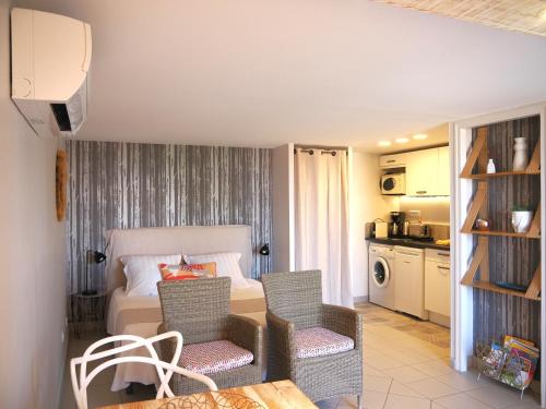 a living room with a bed and a table and chairs at Une Heure Bleue in Manosque