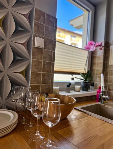 a group of wine glasses sitting on a kitchen counter at The Third Six in Świnoujście