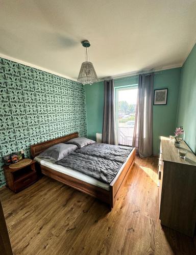 a bedroom with a bed in a room with a window at The Third Six in Świnoujście