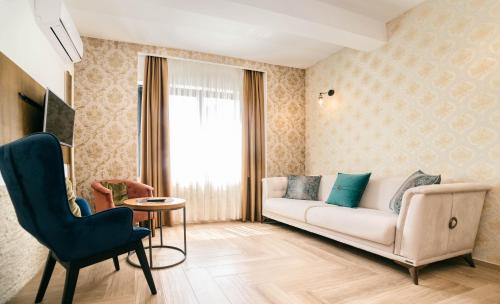 a living room with a couch and a chair at Hotel Platino Prestige in Ulcinj