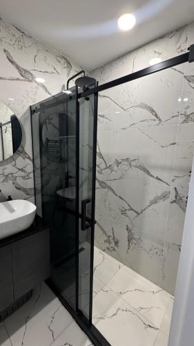 a bathroom with a shower and a sink at Bamboo Beach 358 in Ts'ikhisdziri