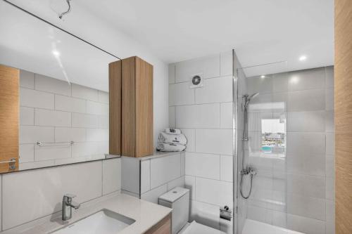 a bathroom with a shower and a toilet and a sink at Marassi Marina Views At BirdNest in Sīdī ‘Abd ar Raḩmān