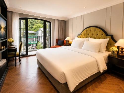 a bedroom with a large bed and a balcony at Palais De Sapa Boutique Hotel in Sapa