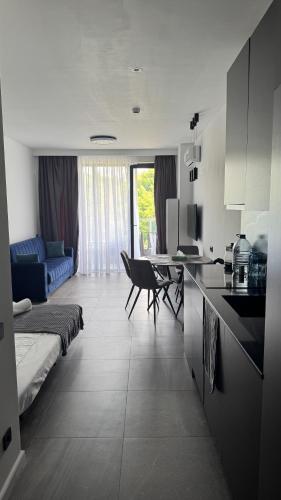 a kitchen and living room with a couch and a table at Bamboo Beach 358 in Ts'ikhisdziri