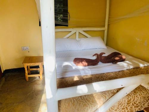 a bunk bed with a monkey and a baby on it at Essie Rovers Camp in Talek