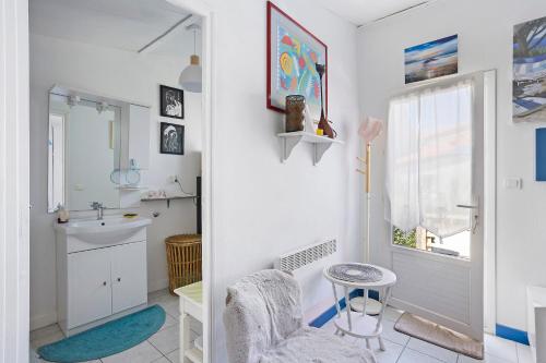 a bathroom with a sink and a toilet and a mirror at Chambre d'hôte Lajarrieleduc in La Jarrie