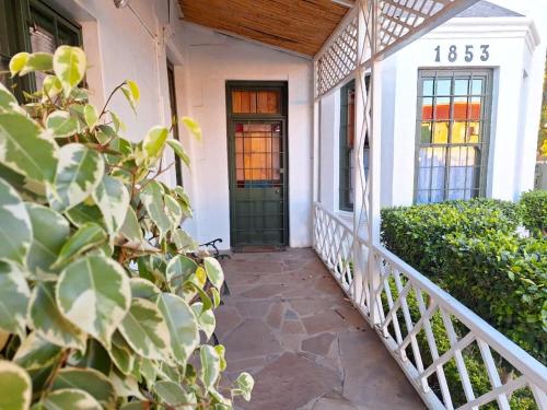 a front porch of a house with a green door at Oakdene Guest House in Oudtshoorn