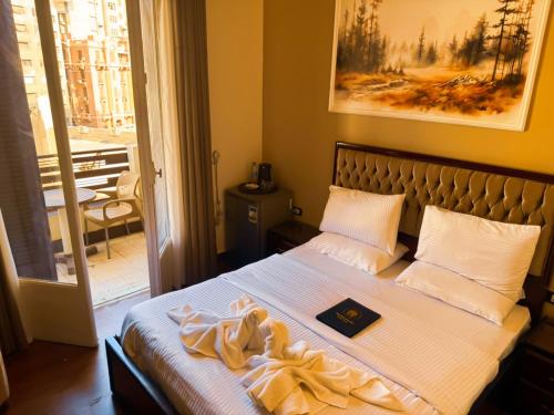 a bedroom with a bed with a picture on the wall at Golden Palace Suites in Cairo