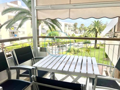 a table and chairs on a balcony with a view at Beach Formentor salou in Salou