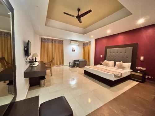 a bedroom with a bed and a red wall at Terrace Valley Hotel in Gangtok