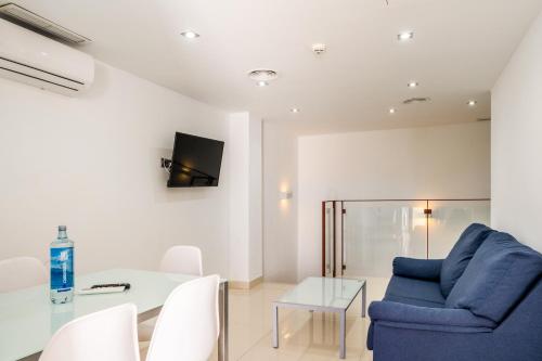 a living room with a blue chair and a table at Soul Beach Hotel By Mc - Adults Recommended in Denia