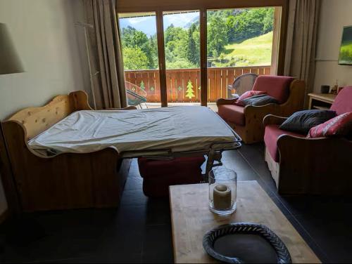 a room with a bed and a table and a window at Pointe de l'Au in Val-d'Illiez