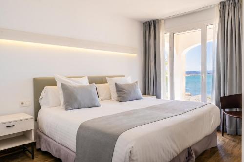 a bedroom with a large bed with a large window at Soul Beach Hotel By Mc - Adults Recommended in Denia