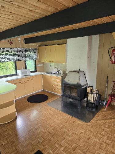 a kitchen with a stove in the middle of it at Revontulet ZH Tuliaalto Moki in Pieksämäki