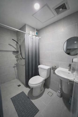 a bathroom with a toilet and a sink at Jtower residences mandaue 12th flr in Mandaue City