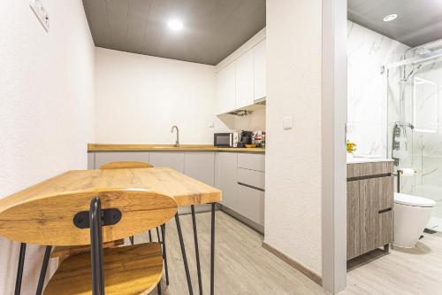 a kitchen with a wooden table and a sink at Flôr do Távora in Vila da Ponte