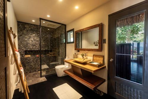 a bathroom with a sink and a toilet and a shower at Cauayan Boutique Private Island - formerly Cauayan Island Resort in El Nido