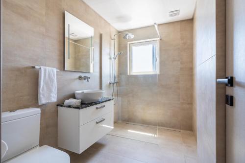 a bathroom with a shower and a toilet and a sink at Limassol Marina Seaview Suite in Limassol