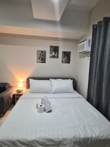 a bedroom with a bed with two towels on it at Jtower residences mandaue 12th flr in Mandaue City