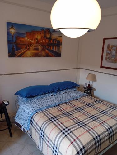 a bedroom with a bed with a picture on the wall at Bed And Breakfast ARIS in Benevento