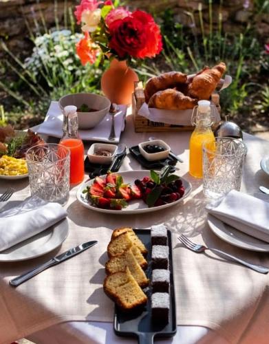 a table with plates of food on a table at Locanda la Rocca Residenza d'Epoca in Fossombrone